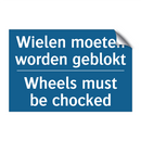 Wielen moeten worden geblokt - Wheels must be chocked