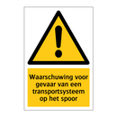 Waarschuwing voor gevaar van een transportsysteem op het spoor